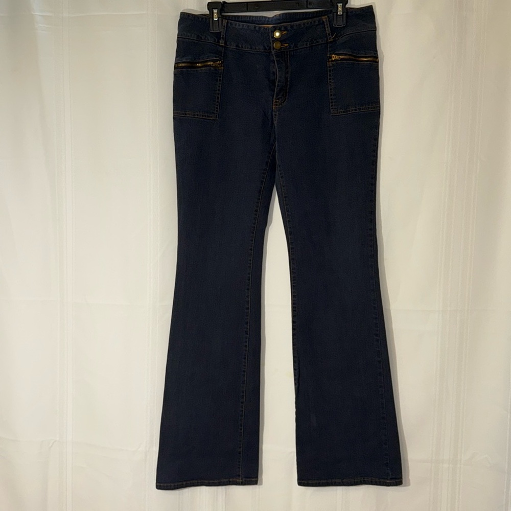 Stretchy, boot cut, blue pants with zipper pockets.